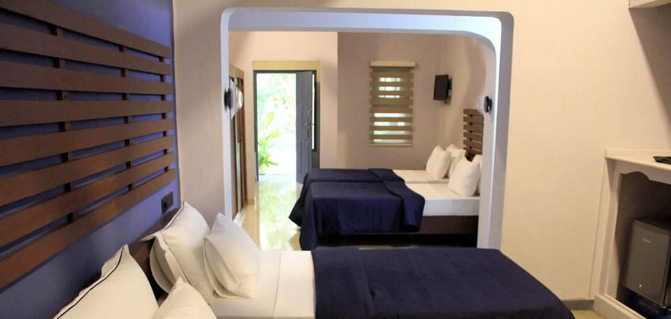 Deluxe Quadruple Room, Patio, Courtyard View | Desk, laptop workspace, free WiFi