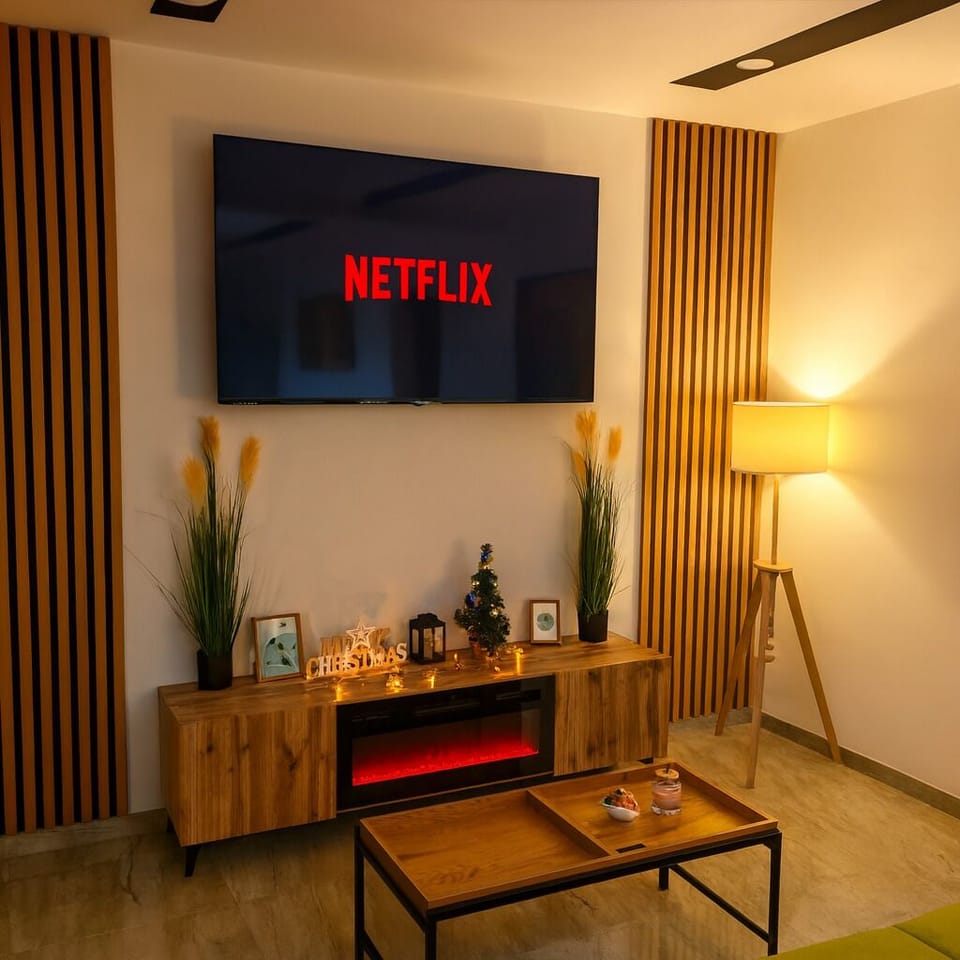 Deluxe Apartment, Garden View | Living area | Flat-screen TV