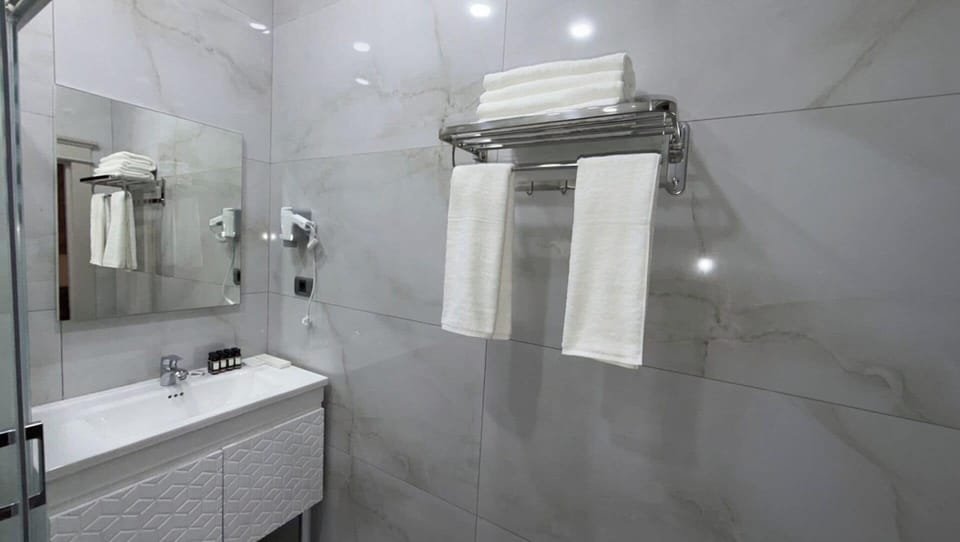 Shower, hair dryer, slippers, towels
