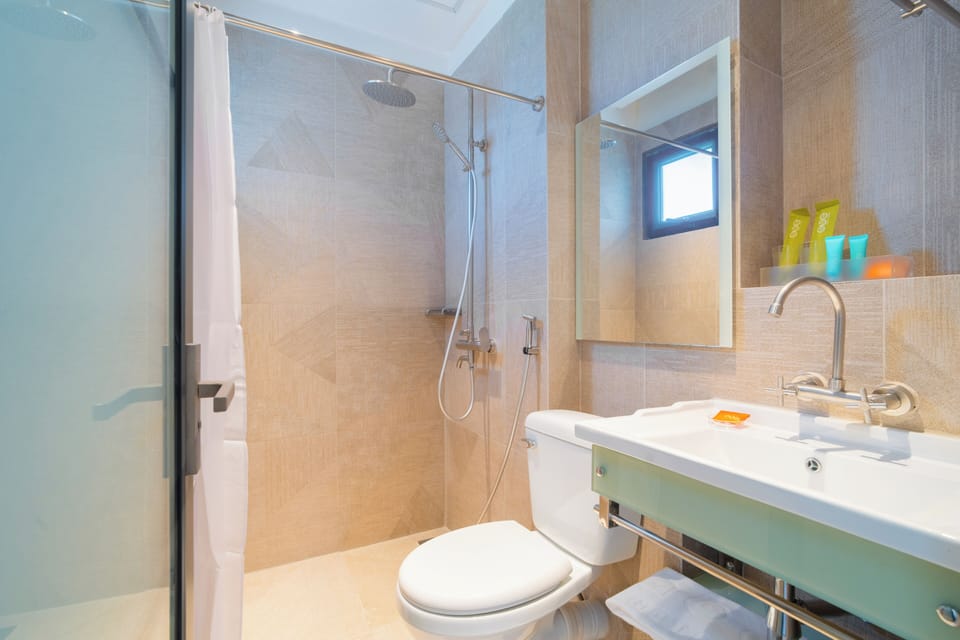 Basic Single Room, 1 Large Twin Bed | Bathroom | Shower, towels, soap, shampoo