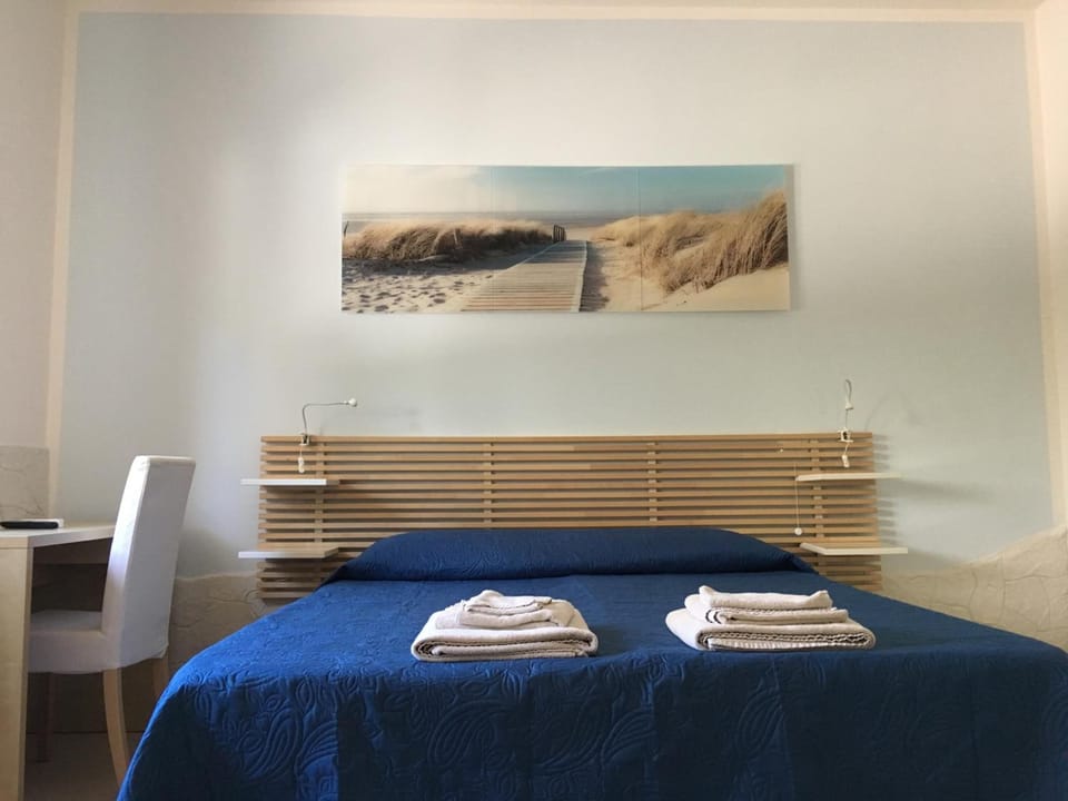 Premium bedding, desk, laptop workspace, blackout drapes