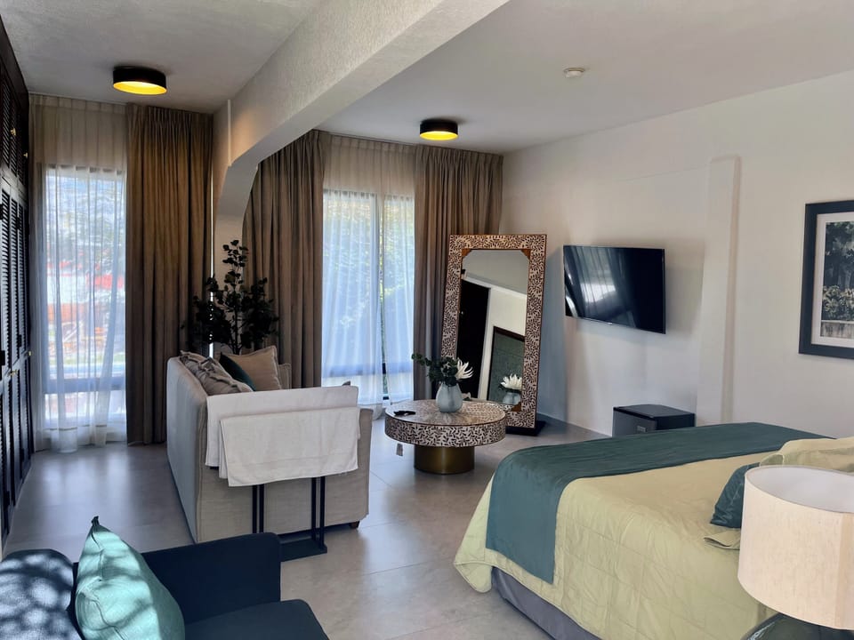 Superior Suite, Pool View | Minibar, in-room safe, laptop workspace, blackout drapes