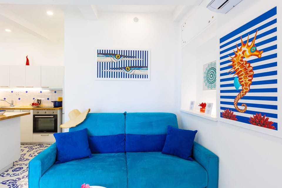 Deluxe Apartment, Sea View | Living area | 32-inch flat-screen TV with digital channels