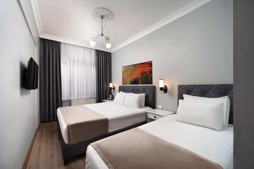 Classic Triple Room, City View | Minibar, in-room safe, desk, laptop workspace