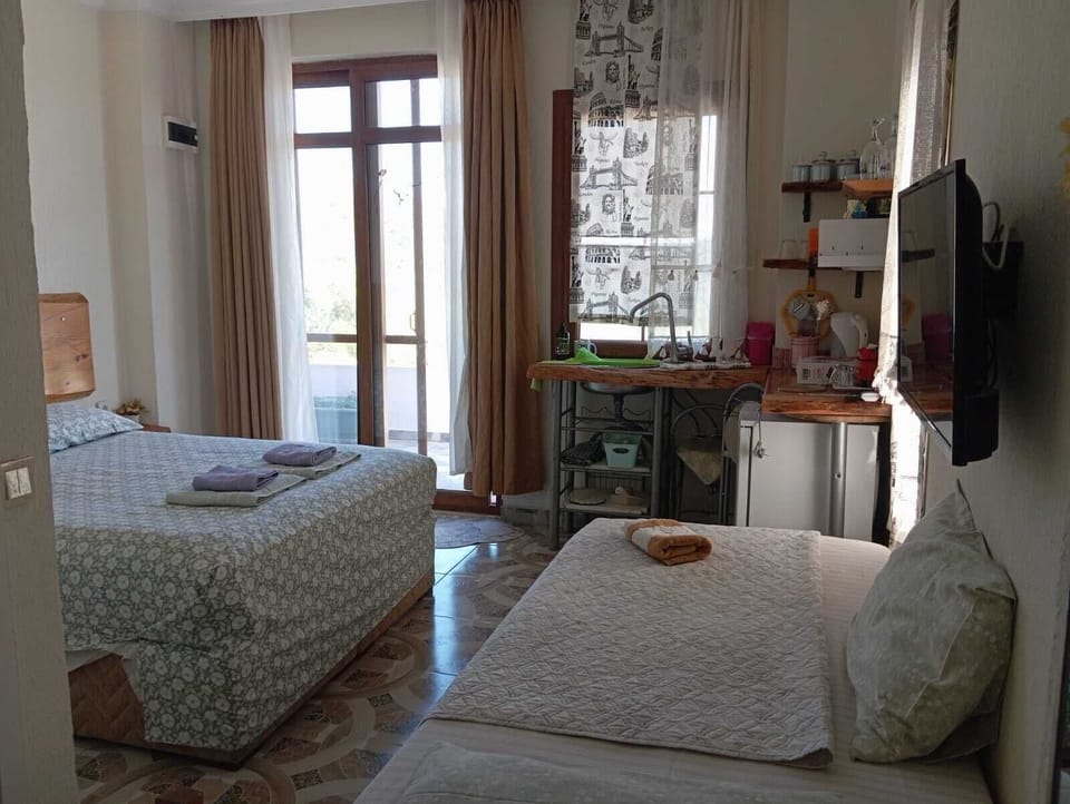 Deluxe Triple Room, Garden View | Private kitchenette | Electric kettle