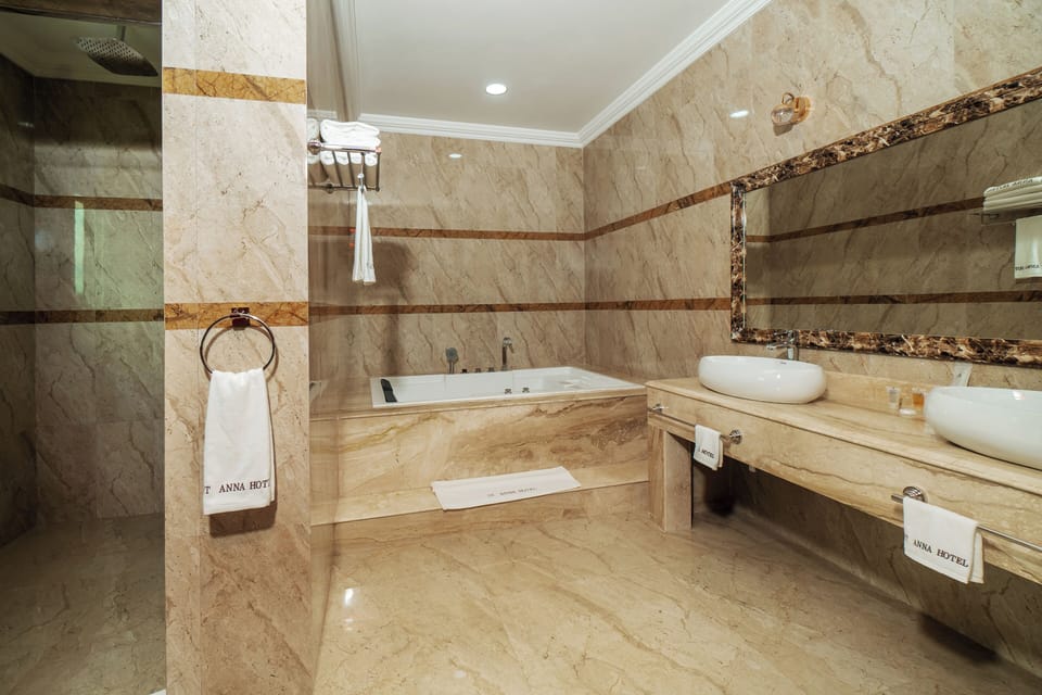 Superior Suite, Balcony, Courtyard View | Bathroom | Separate tub and shower, hair dryer, slippers, towels