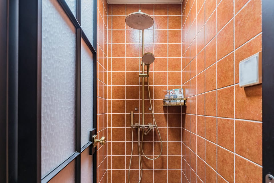 Double Room Single Use, Garden View | Bathroom | Shower, rainfall showerhead, hair dryer, slippers