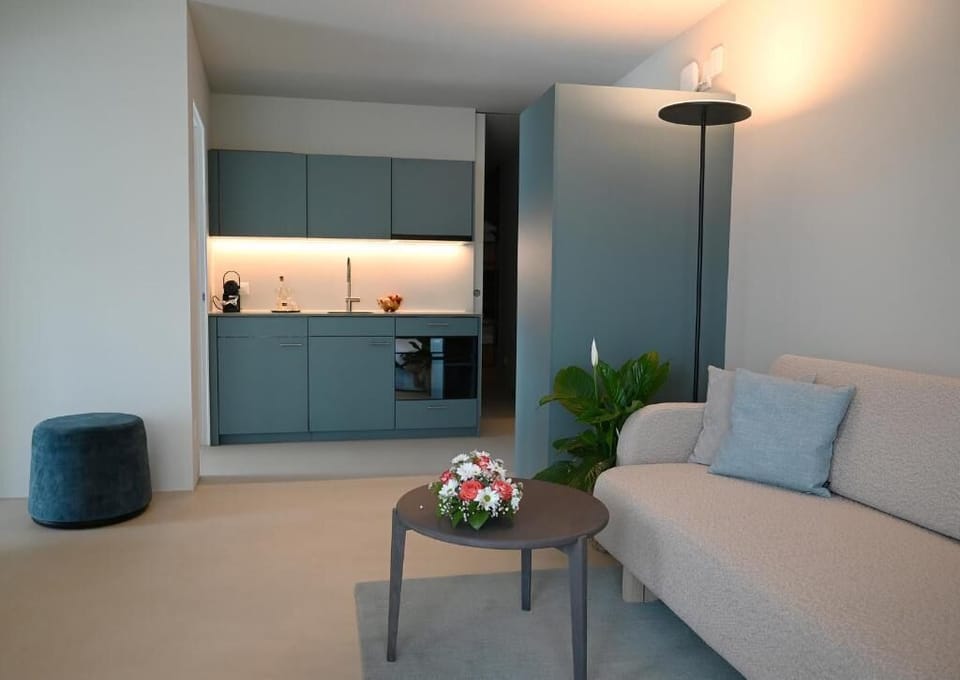 Luxury Suite, Balcony, Lake View | Living area | TV