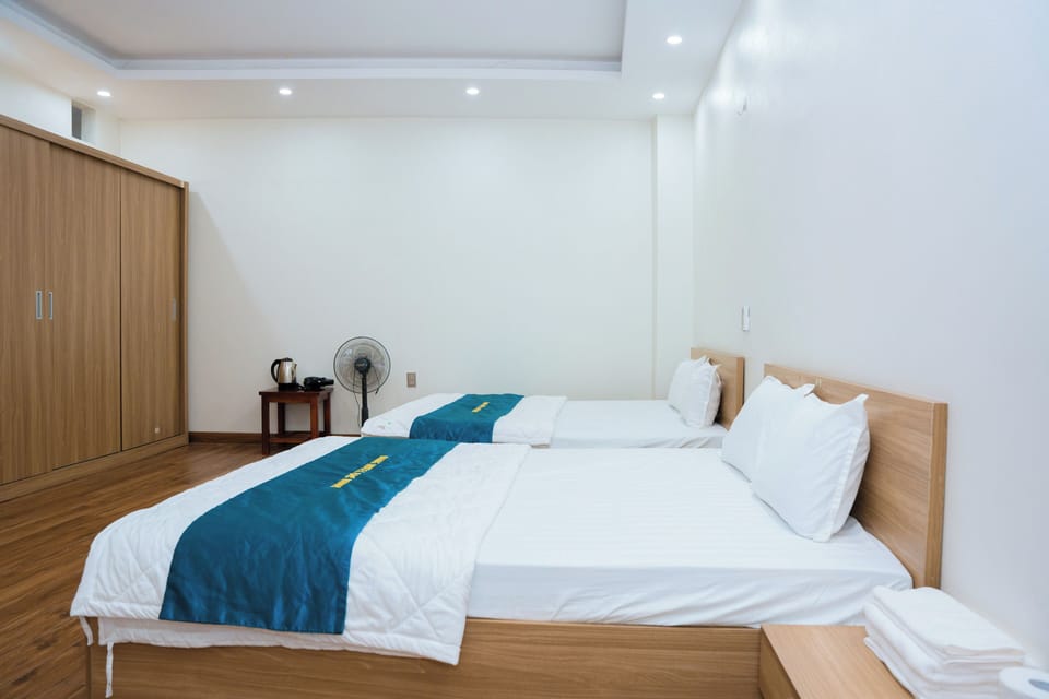 Deluxe Room, Multiple Beds, Balcony, City View | Desk, laptop workspace, free WiFi