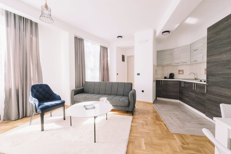 Deluxe Apartment, 1 Bedroom, Balcony, Sea View | Living area | 50-inch Smart TV with cable channels, Netflix, toys