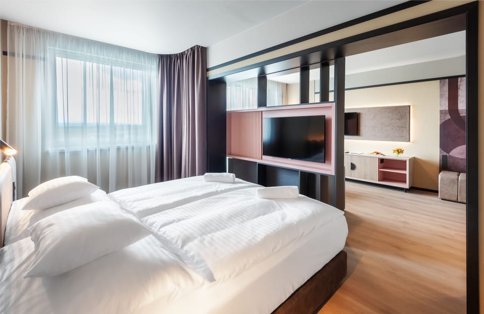 Junior Suite | Minibar, in-room safe, blackout drapes, free WiFi