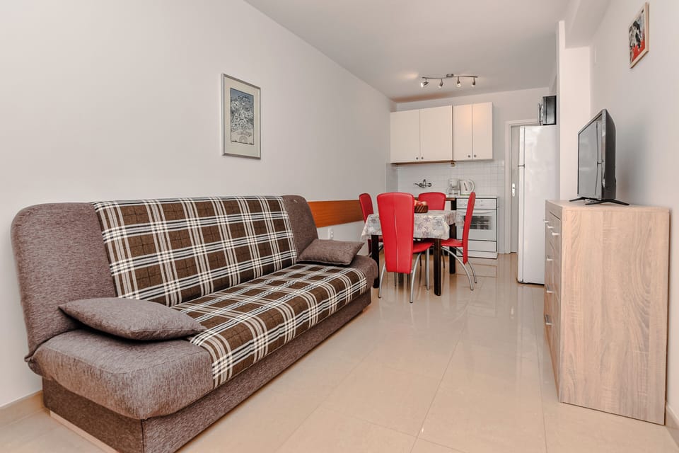 Classic Apartment, Garden View | Living area | 100-cm LCD TV with satellite channels