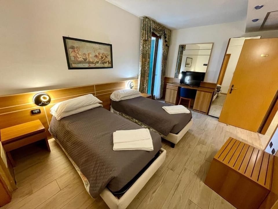 Family Twin Room, Private Bathroom | Minibar, in-room safe, desk, laptop workspace