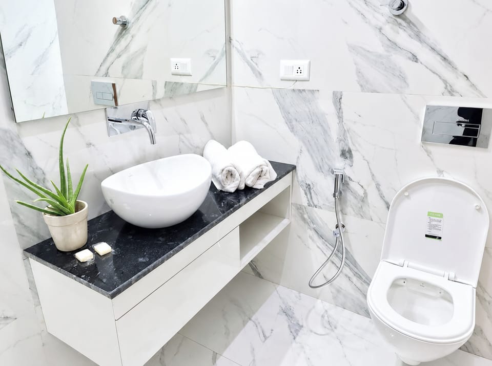 Shower, rainfall showerhead, slippers, towels