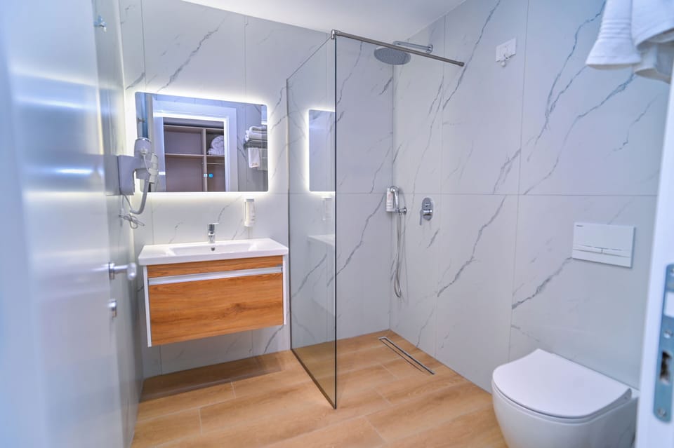 Shower, hair dryer, slippers, towels