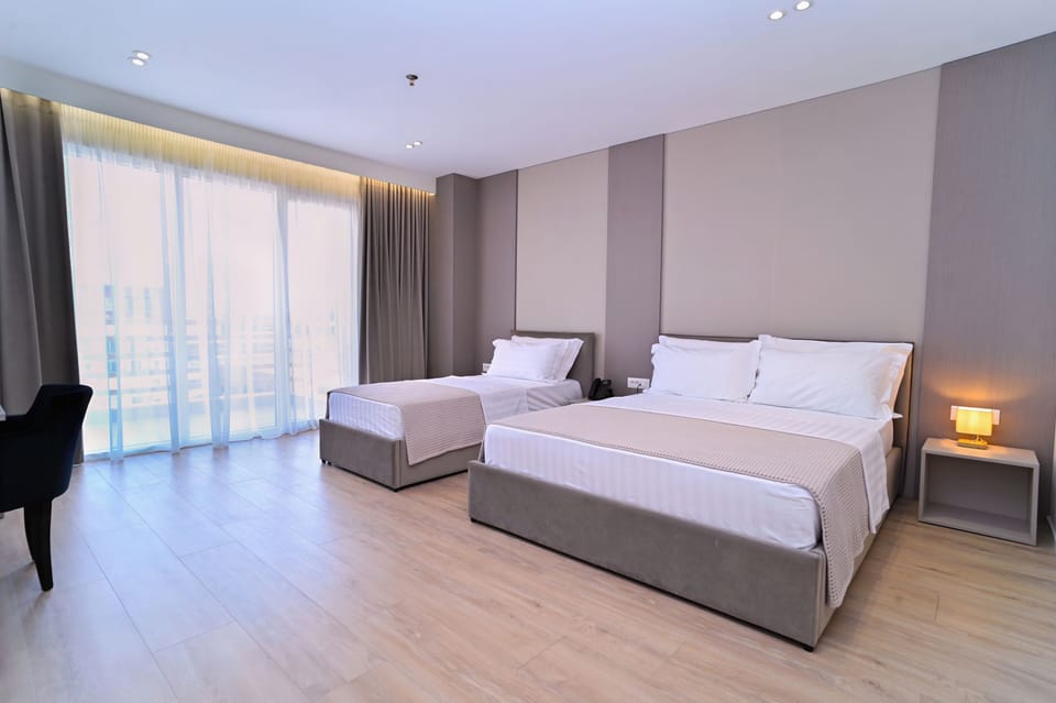 Superior Triple Room, Balcony | In-room safe, desk, laptop workspace, blackout drapes