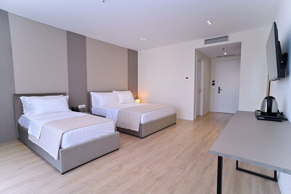 Superior Triple Room, Balcony | In-room safe, desk, laptop workspace, blackout drapes