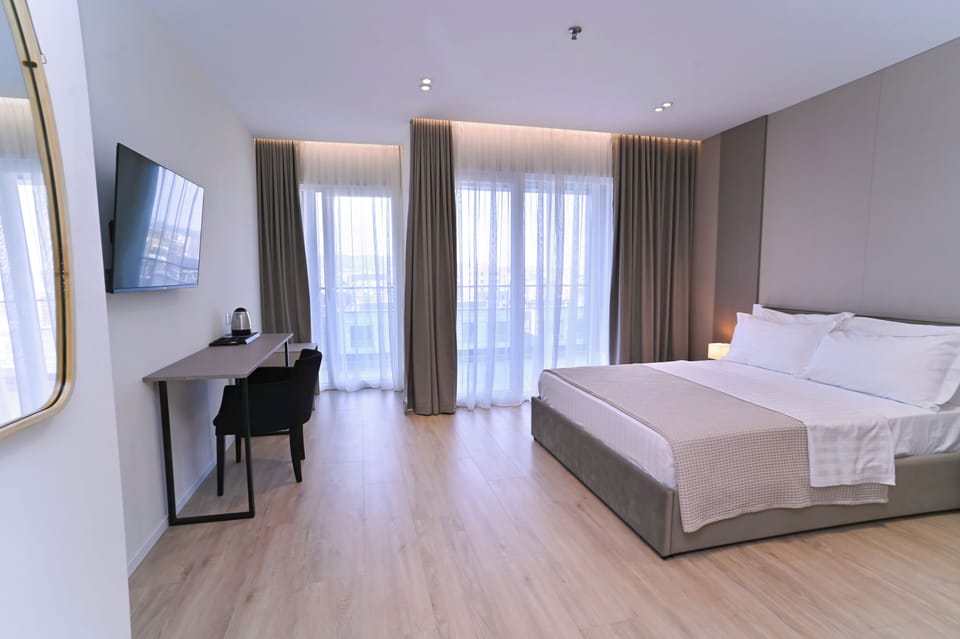 Superior Double Room, Balcony | In-room safe, desk, laptop workspace, blackout drapes