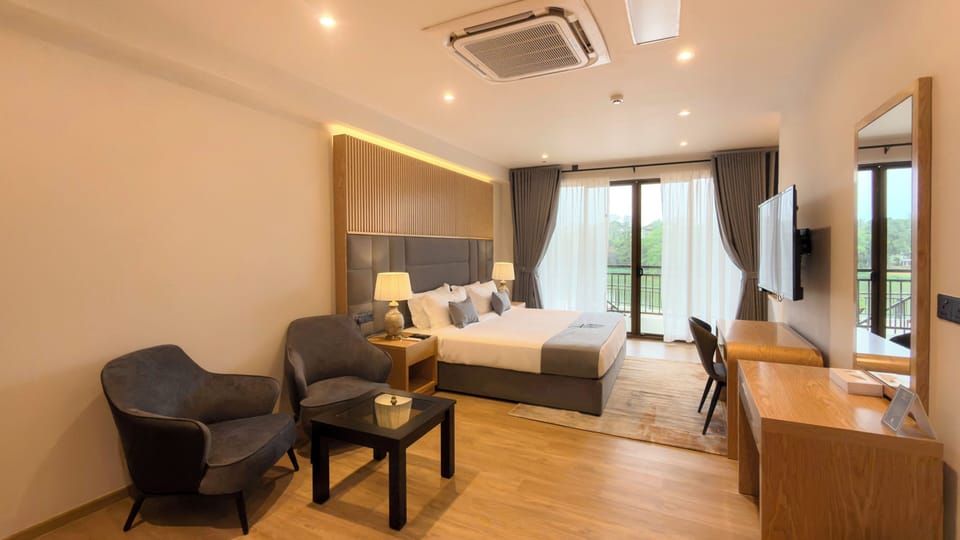 Deluxe Suite, Balcony, River View | Hypo-allergenic bedding, in-room safe, soundproofing, iron/ironing board