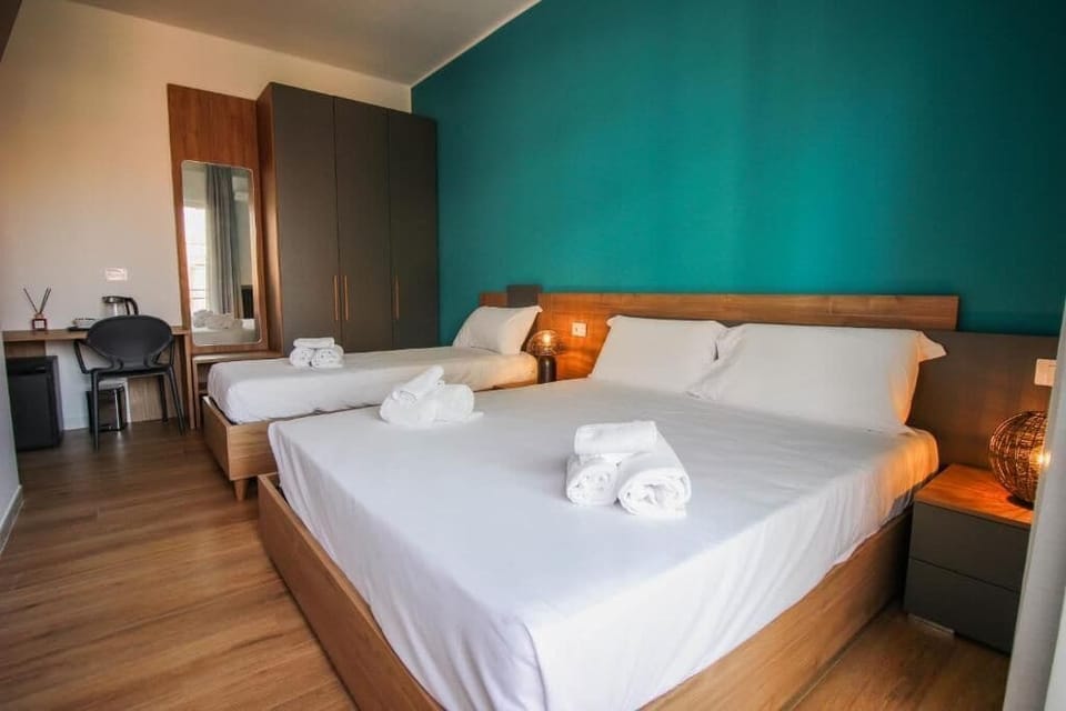 Luxury Triple Room, Balcony | Minibar, in-room safe, desk, laptop workspace