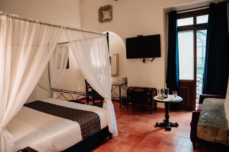 Deluxe Suite, Balcony, City View | In-room safe, blackout drapes, soundproofing, iron/ironing board
