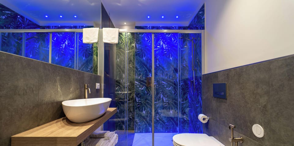 Deluxe Townhome, Balcony, City View | Bathroom | Shower, rainfall showerhead, hair dryer, slippers