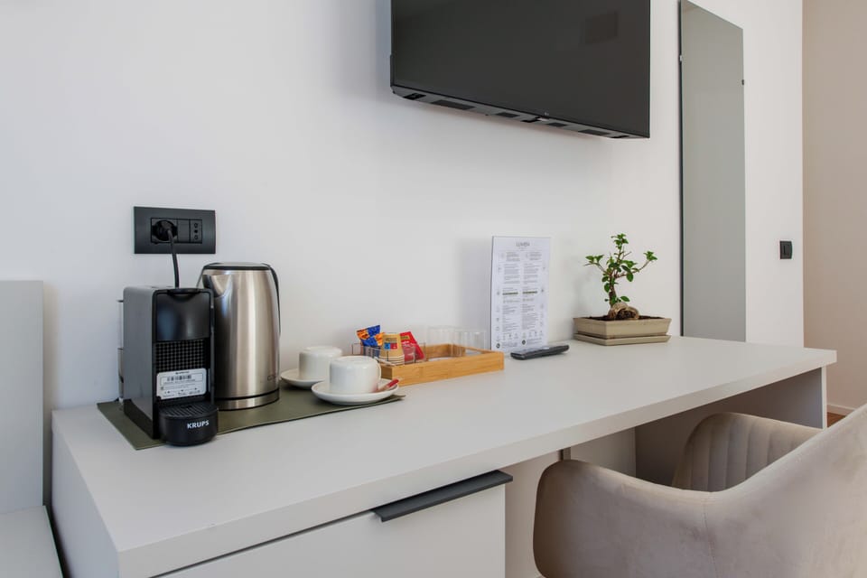 Luxury Triple Room, City View | Memory foam beds, minibar, desk, laptop workspace
