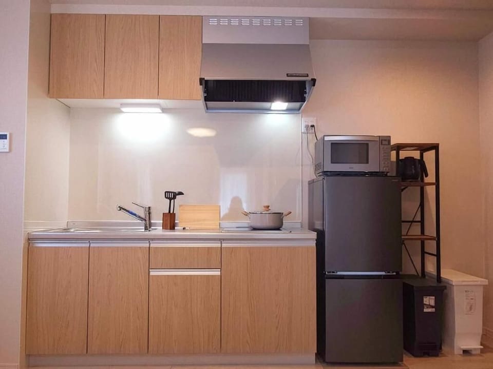 Apartment, Multiple Beds, Non Smoking | Private kitchen | Full-size fridge, microwave, stovetop, cookware/dishes/utensils