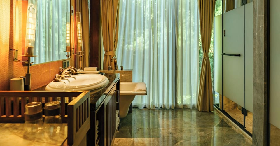Exclusive Duplex, Garden View | Bathroom | Hair dryer, slippers, towels, soap