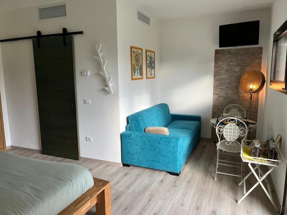 Deluxe Quadruple Room, Multiple Beds, Smoking, Park View | Living area | 45-cm Smart TV with cable channels