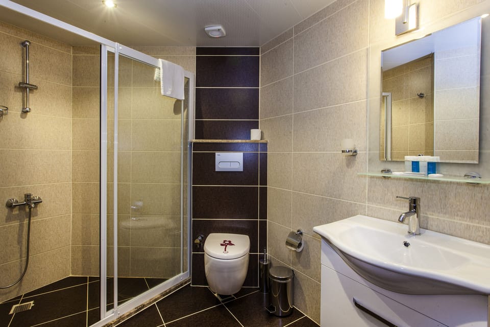 Suite, Sea View | Bathroom | Shower, free toiletries, hair dryer, slippers