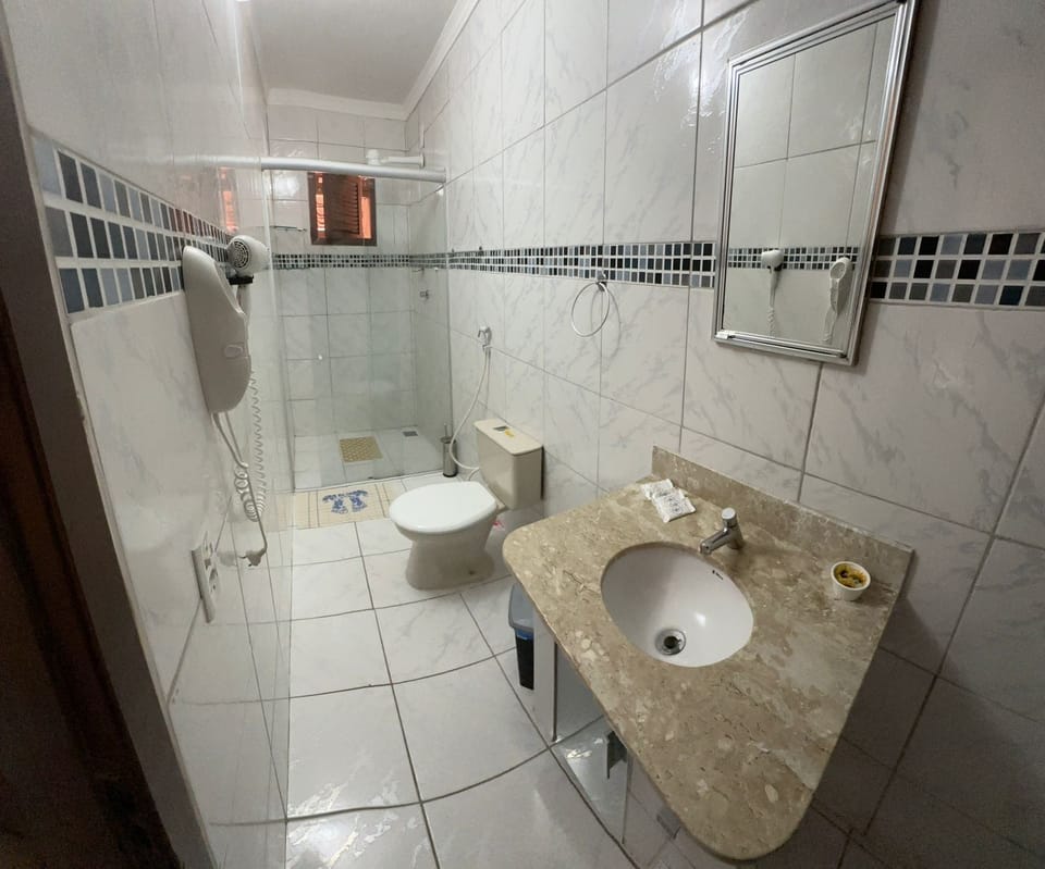Deluxe Room | Bathroom | Hair dryer, towels, soap, toilet paper