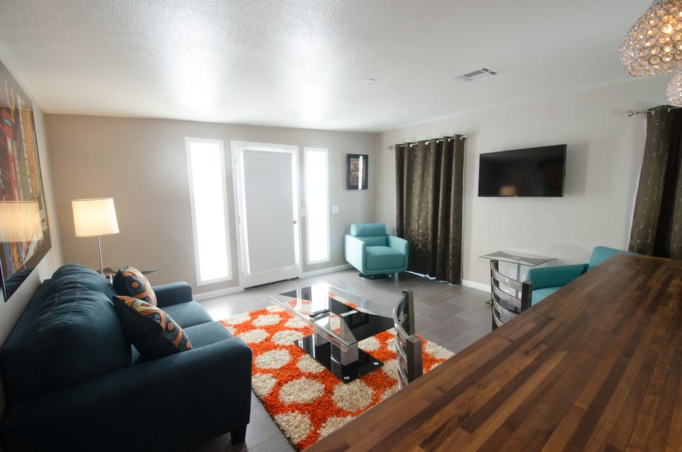 Exclusive Suite, 1 King Bed, Patio, Poolside | Living room | Flat-screen TV