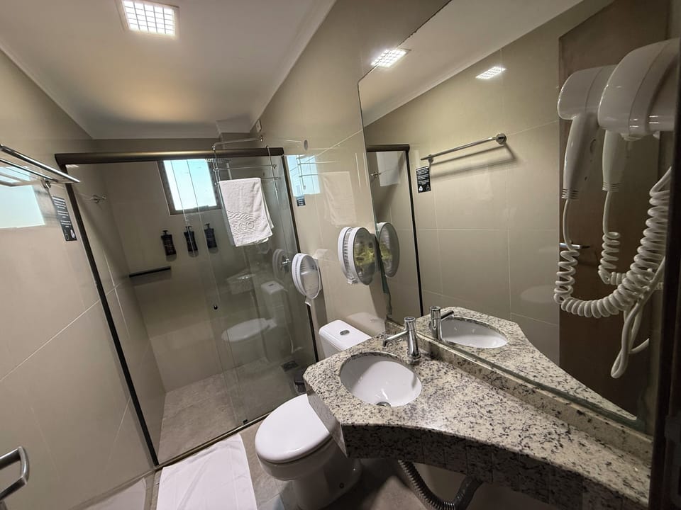 Shower, rainfall showerhead, hair dryer, towels