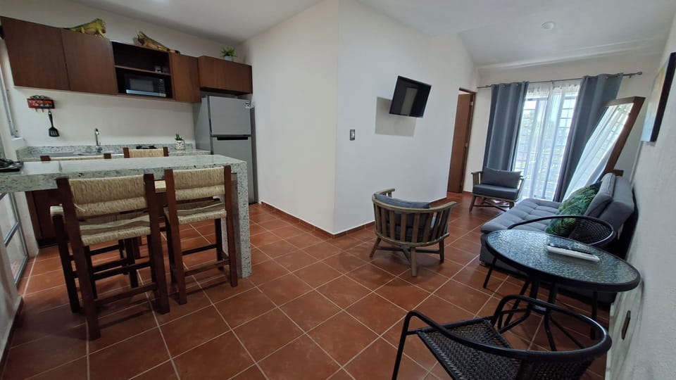 Basic Apartment, Ocean View | Living area | 32-inch LED TV with digital channels, streaming services