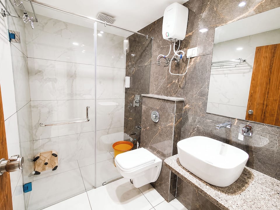Shower, rainfall showerhead, slippers, towels