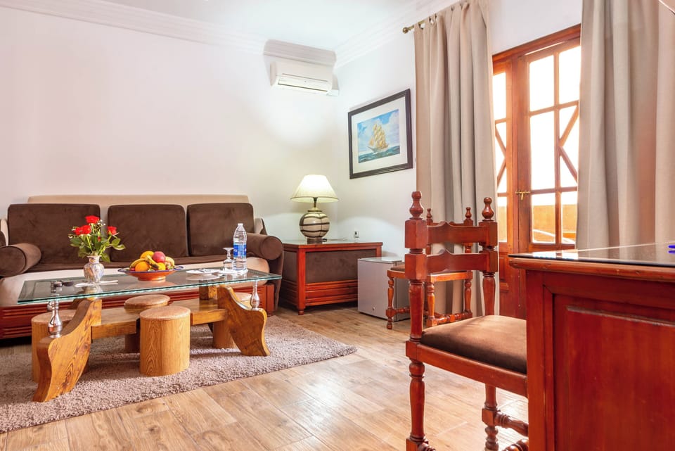 Standard Quadruple Room | Living area | Flat-screen TV