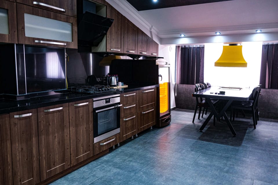 Premium Studio Suite, 1 King Bed, City View | Private kitchen | Fridge, electric kettle, cleaning supplies, paper towels