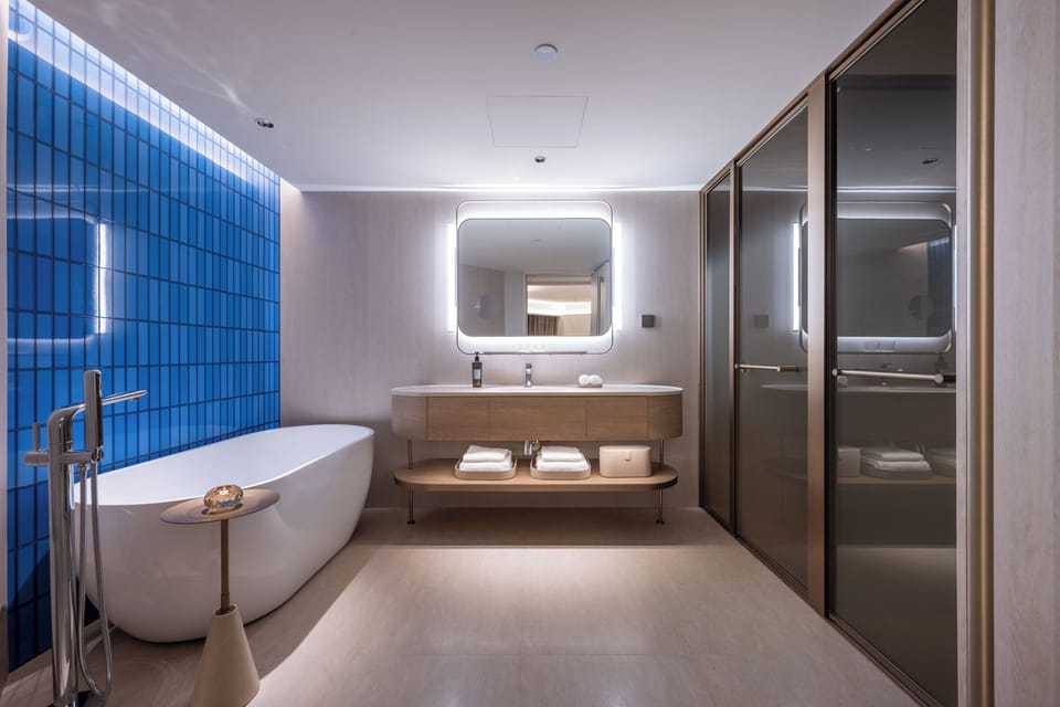 Suite | Bathroom | Rainfall showerhead, hair dryer, bathrobes, slippers