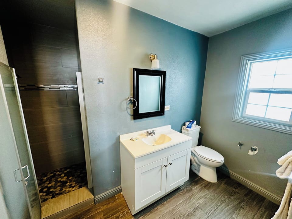 Deluxe Suite, Patio, Garden View | Bathroom | Shower, free toiletries, towels, soap