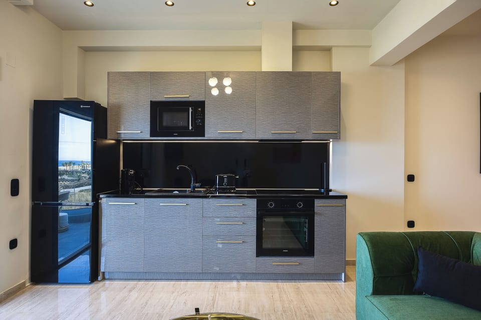 Deluxe Suite, Balcony, Sea View | Private kitchen | Full-size fridge, microwave, oven, highchair
