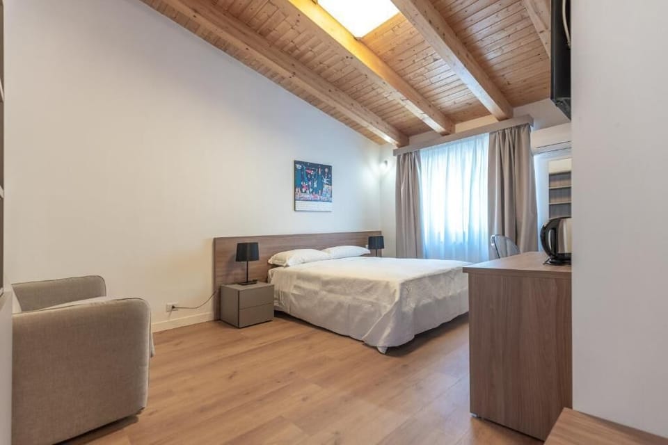 Superior Triple Room, Garden View | In-room safe, desk, soundproofing, iron/ironing board