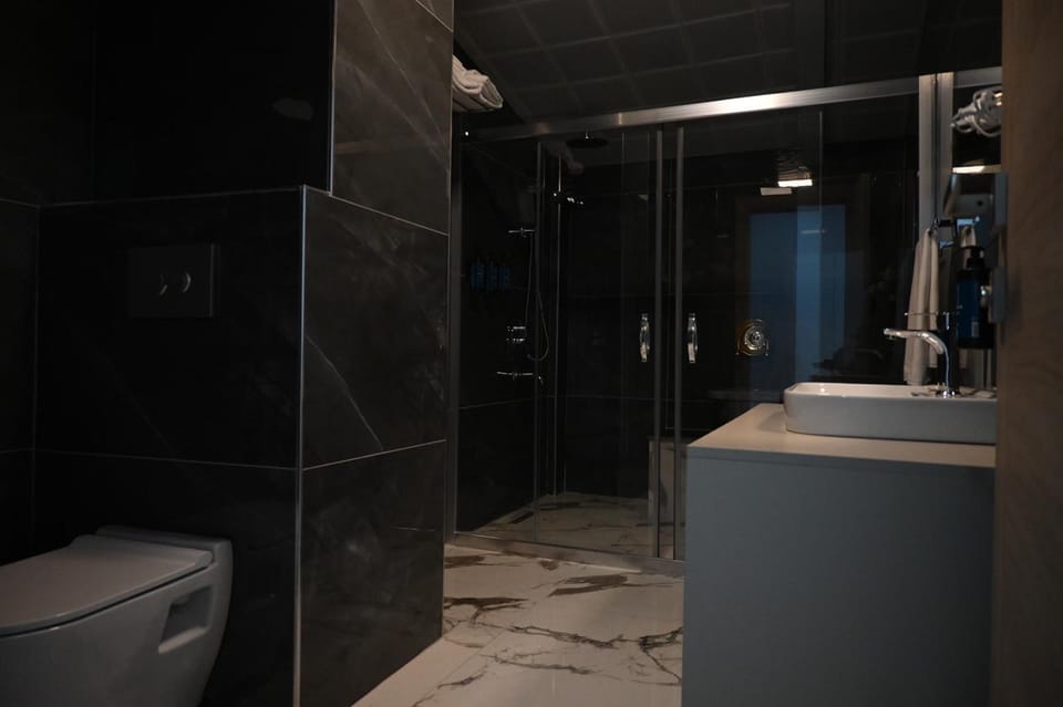 Family Suite, Balcony, City View | Bathroom | Shower, rainfall showerhead, hair dryer, slippers