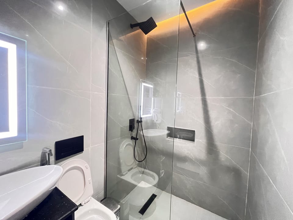 Shower, hair dryer, slippers, towels