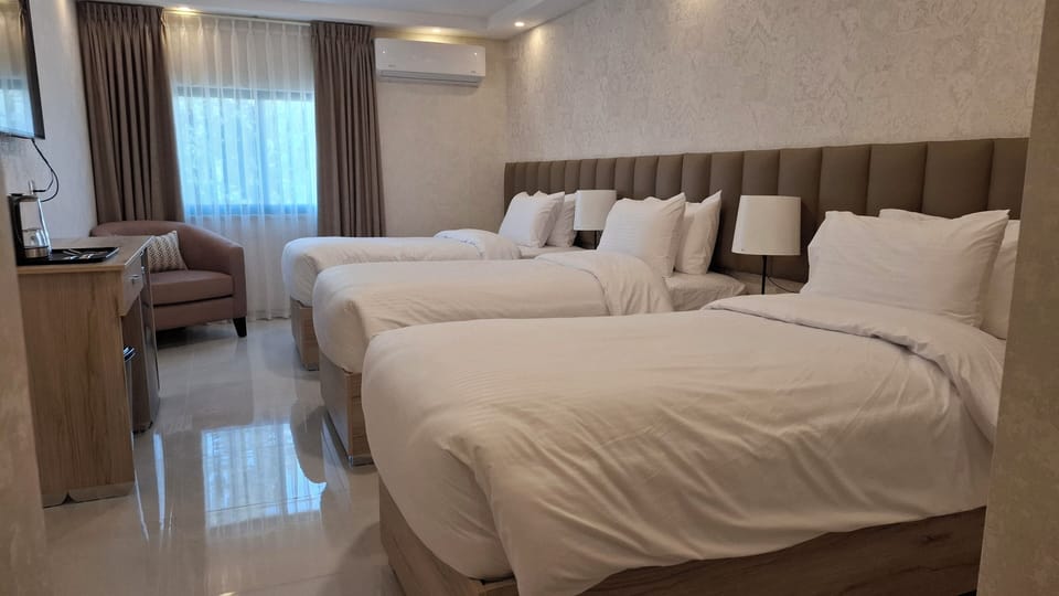 Deluxe Triple Room | Hypo-allergenic bedding available, pillowtop beds, in-room safe, desk