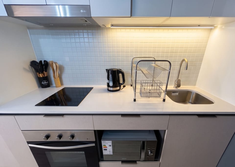 Apartment | Private kitchen | Full-size fridge, microwave, oven, cookware/dishes/utensils