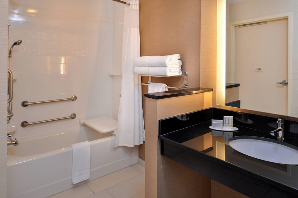 Designer toiletries, hair dryer, towels