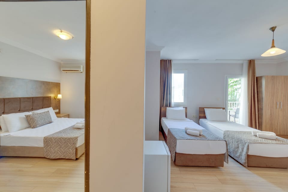 Family Suite, Balcony, Garden View | Hypo-allergenic bedding available, in-room safe, blackout drapes