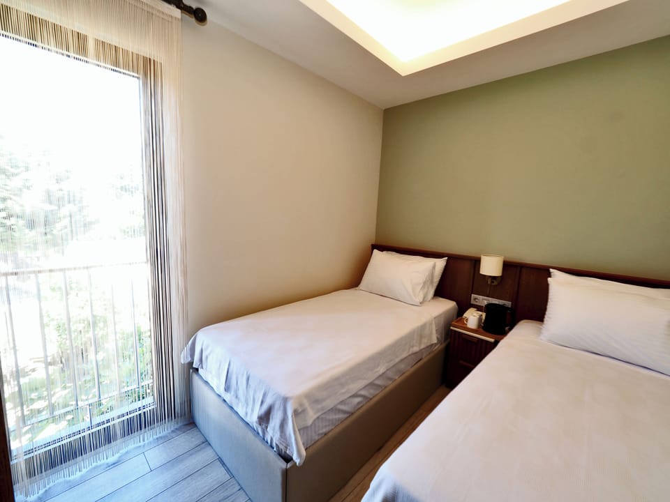 Superior Quadruple Room, City View | Minibar, in-room safe, laptop workspace, soundproofing