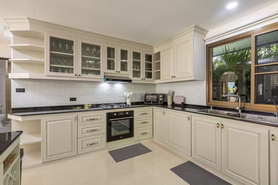 Four-Bedroom House | Private kitchen | Fridge, microwave, cookware/dishes/utensils, dining table